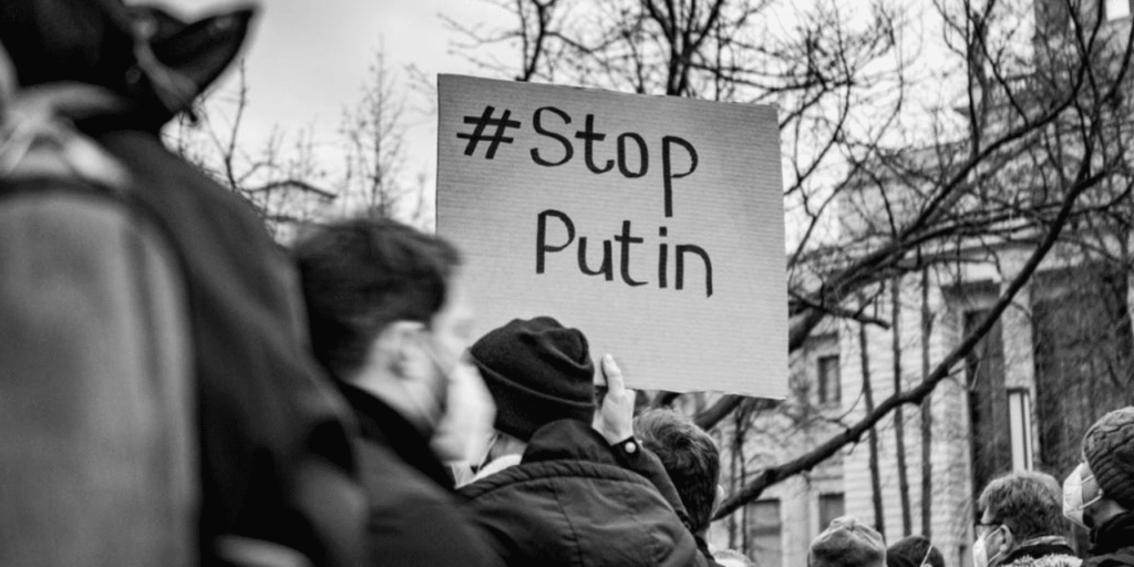 Protester holding Stop Putin placard